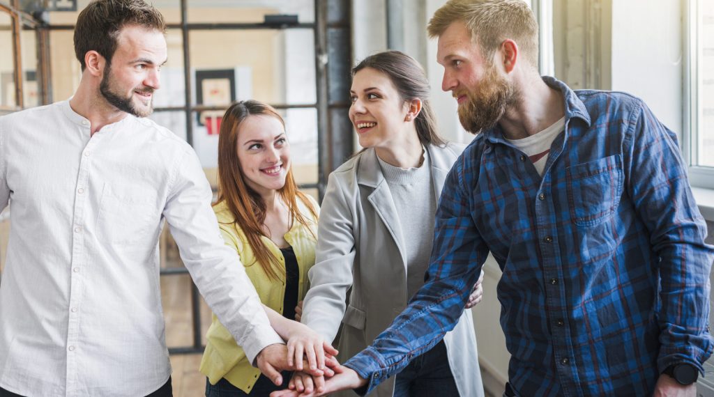group-businesspeople-stacking-their-hand-office